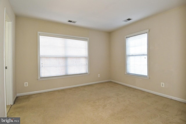 unfurnished room with light colored carpet