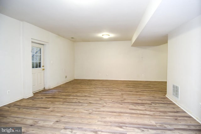 unfurnished room with light wood-type flooring