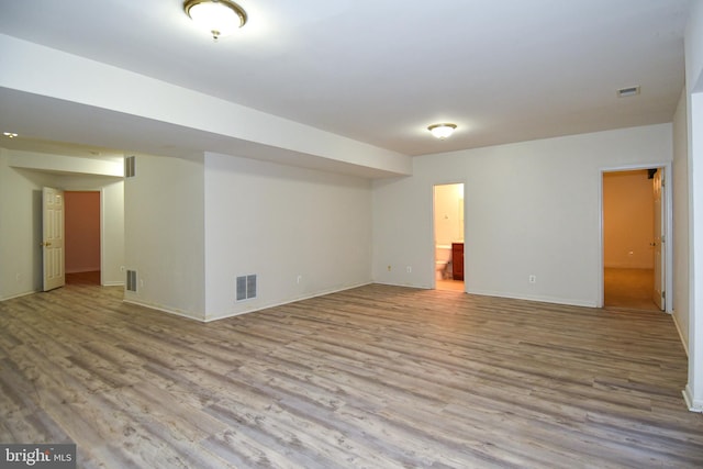 basement with light hardwood / wood-style flooring