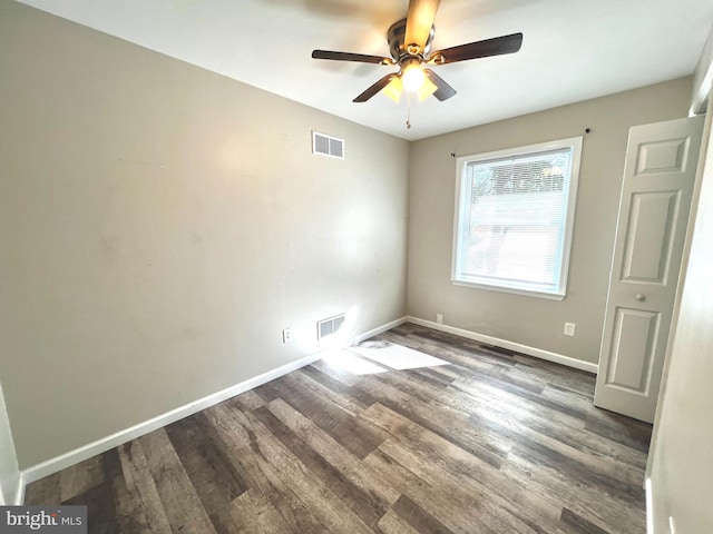 unfurnished room with ceiling fan and dark hardwood / wood-style flooring