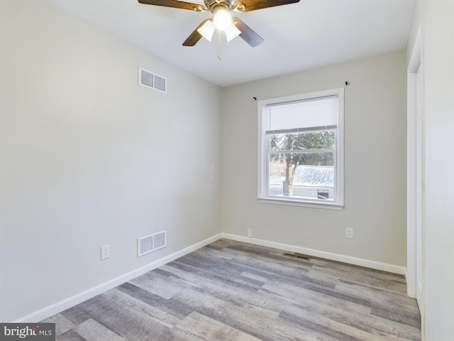 unfurnished room with ceiling fan and light wood-type flooring