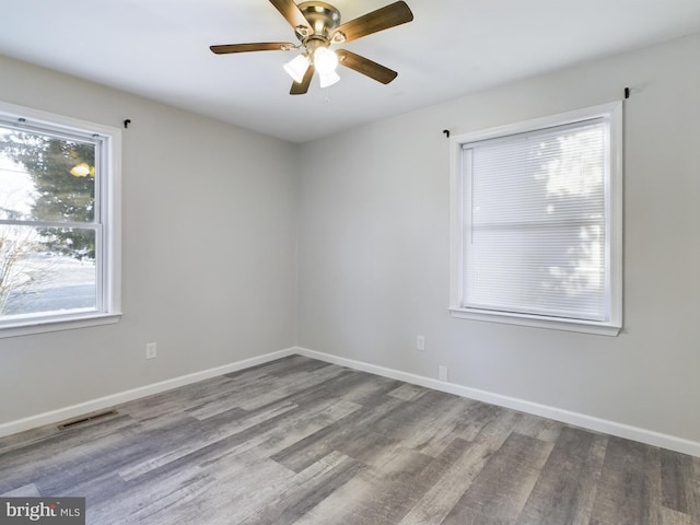 spare room featuring hardwood / wood-style flooring and ceiling fan