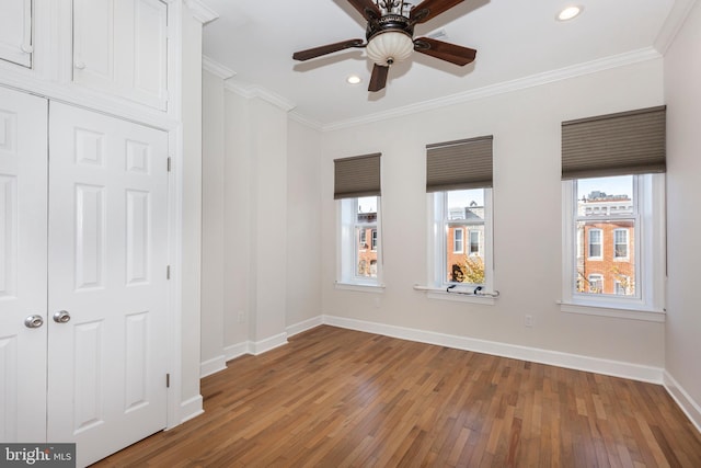 spare room featuring ornamental molding, hardwood / wood-style floors, and ceiling fan