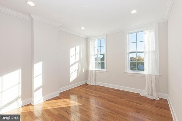 empty room with crown molding and hardwood / wood-style flooring