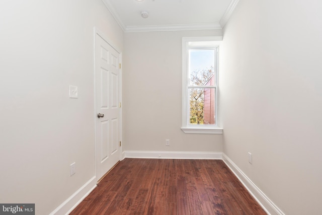 unfurnished room featuring ornamental molding and dark wood-type flooring