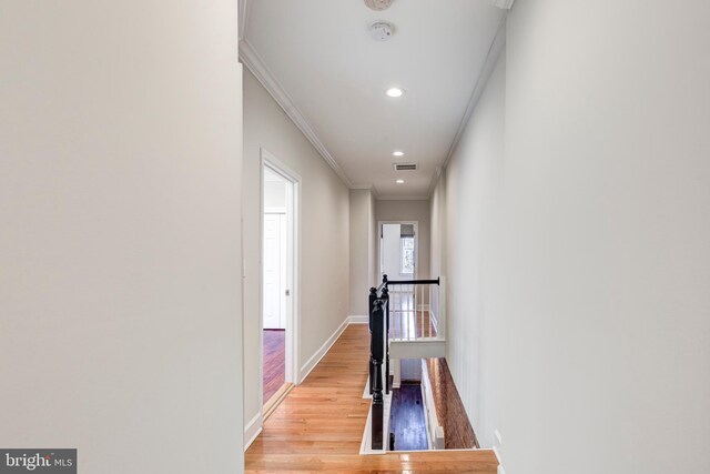 hall featuring crown molding and light wood-type flooring