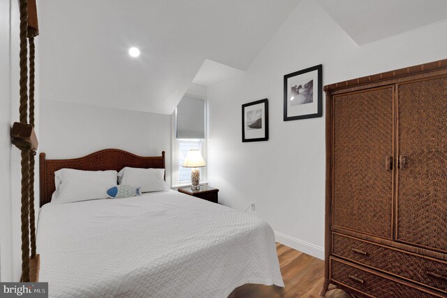 694 21st St, Avalon, NJ 08202 - bedroom with vaulted ceiling, wood finished floors, and baseboards