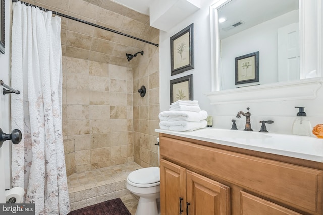 694 21st St, Avalon, NJ 08202 - bathroom featuring visible vents, toilet, vanity, and a tile shower