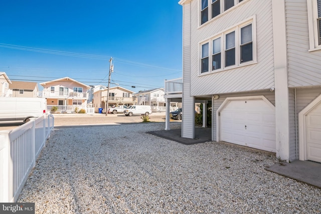 694 21st St, Avalon, NJ 08202 - exterior space featuring a garage, fence, and a residential view