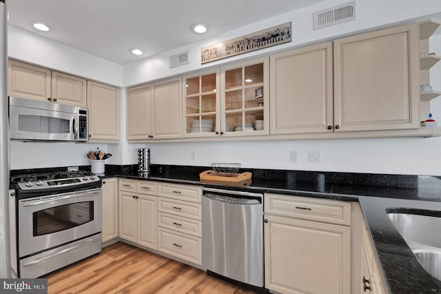 694 21st St, Avalon, NJ 08202 - kitchen featuring visible vents, stainless steel appliances, glass insert cabinets, and light wood finished floors