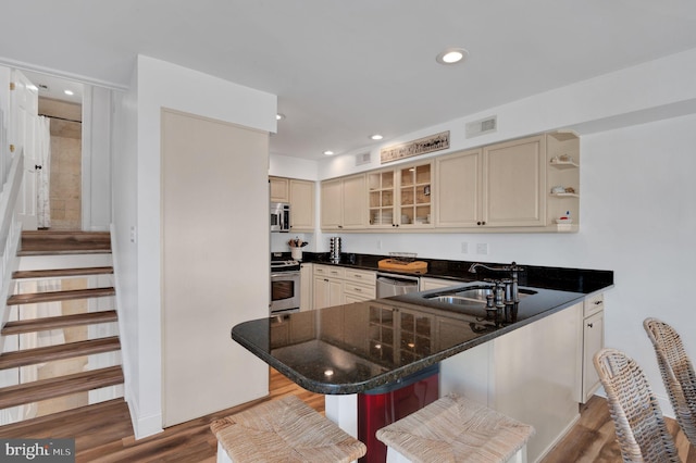 694 21st St, Avalon, NJ 08202 - kitchen featuring a sink, visible vents, stainless steel appliances, cream cabinets, and wood finished floors