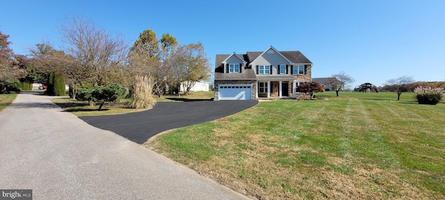 view of front facade featuring a garage and a front lawn