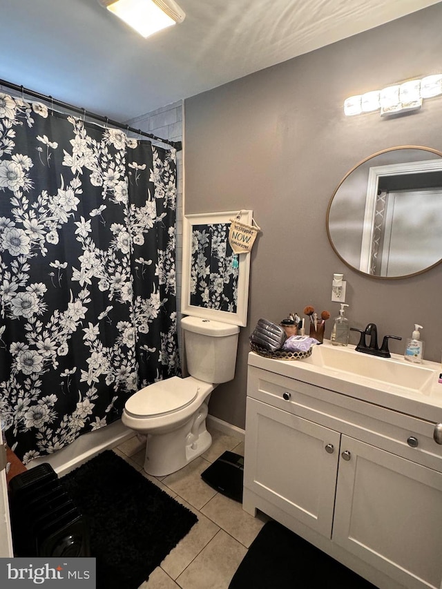 bathroom featuring toilet, vanity, and tile patterned floors