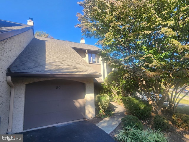 view of side of home featuring a garage