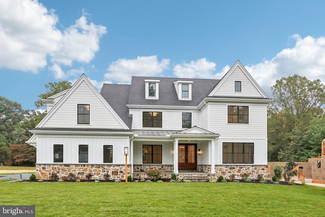 modern farmhouse with a front yard and a porch