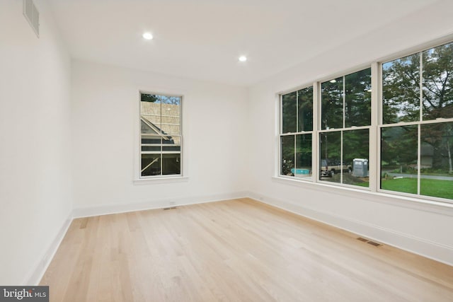 unfurnished room with light hardwood / wood-style floors