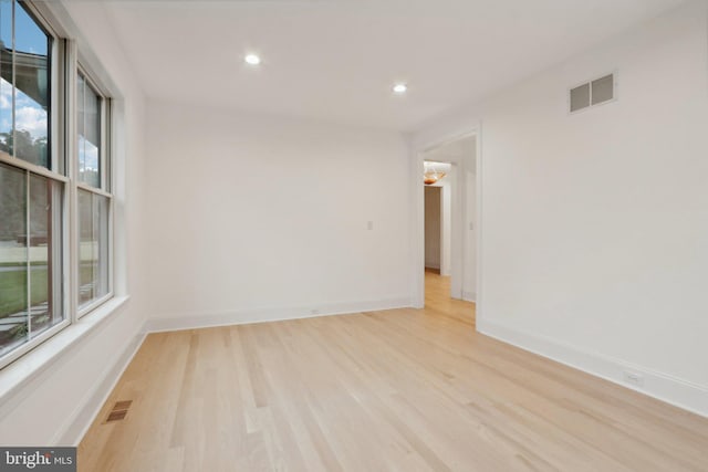 spare room with light hardwood / wood-style flooring