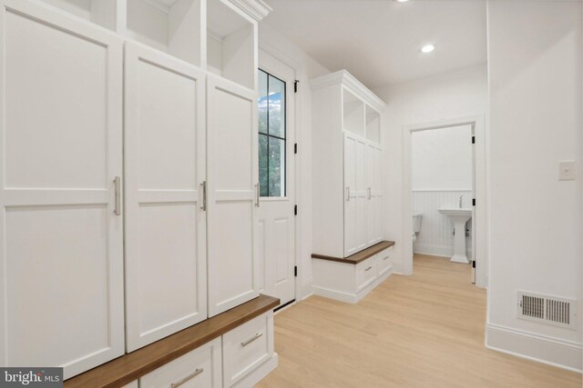 mudroom with light hardwood / wood-style floors