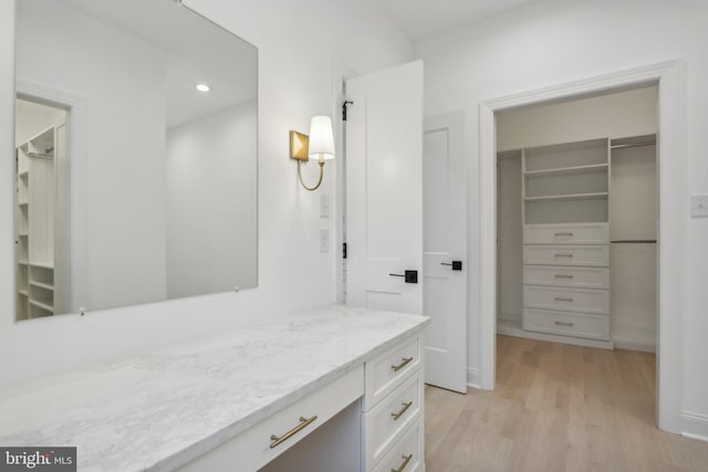 bathroom with vanity and hardwood / wood-style floors