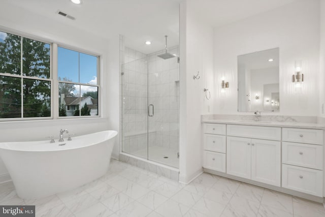 bathroom with vanity and independent shower and bath