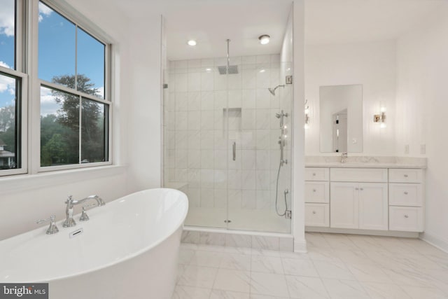 bathroom with vanity and separate shower and tub