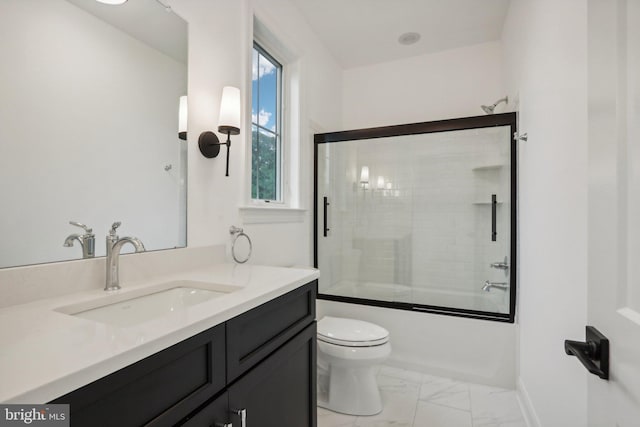 full bathroom featuring toilet, vanity, shower / bath combination with glass door, and a wealth of natural light