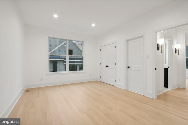 unfurnished room with light hardwood / wood-style floors