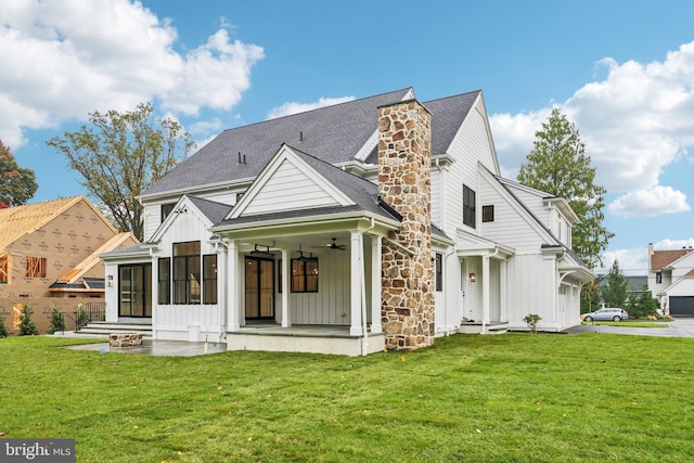 rear view of property featuring a patio area, a yard, and ceiling fan