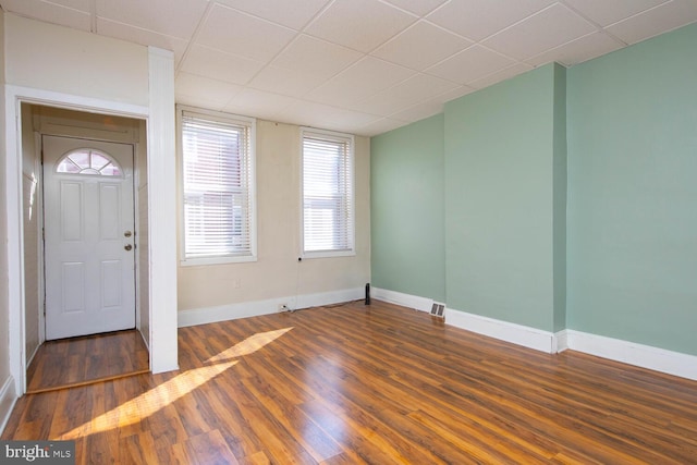 entryway featuring dark hardwood / wood-style floors and a paneled ceiling