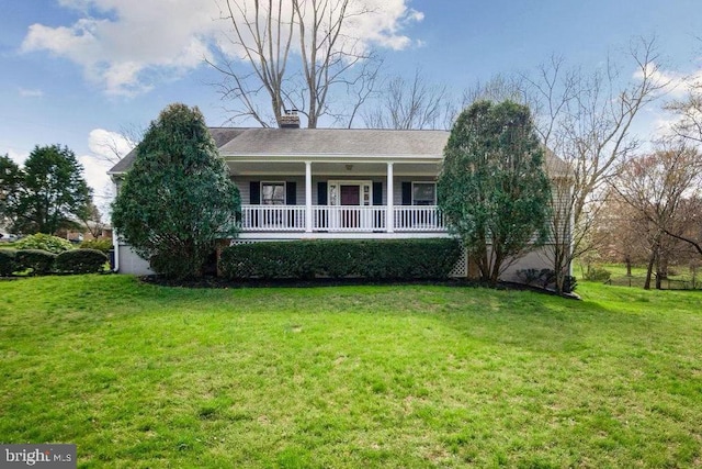 ranch-style home with a front lawn and covered porch