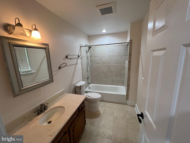 full bathroom featuring toilet, tiled shower / bath combo, and vanity