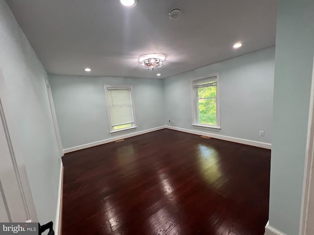 empty room featuring dark wood-type flooring