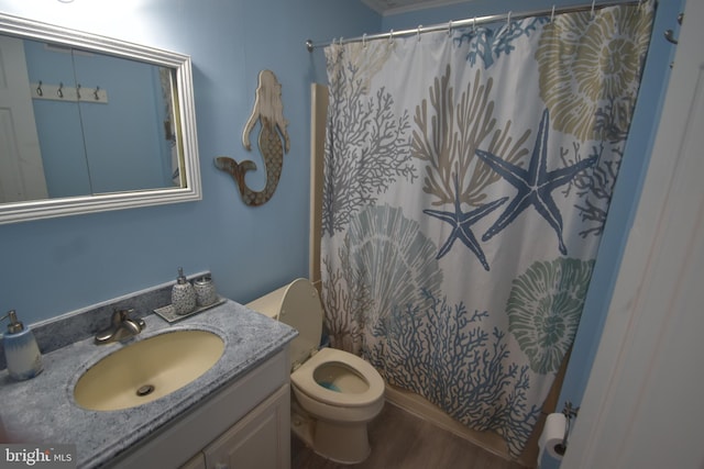 bathroom with vanity, curtained shower, hardwood / wood-style flooring, and toilet