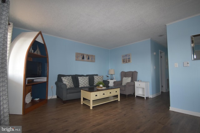 living room featuring ornamental molding, a textured ceiling, and dark wood-type flooring