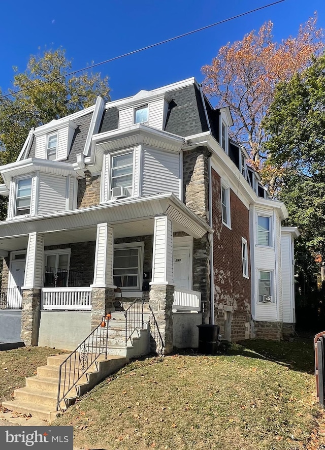 view of front of home with a front yard and a porch