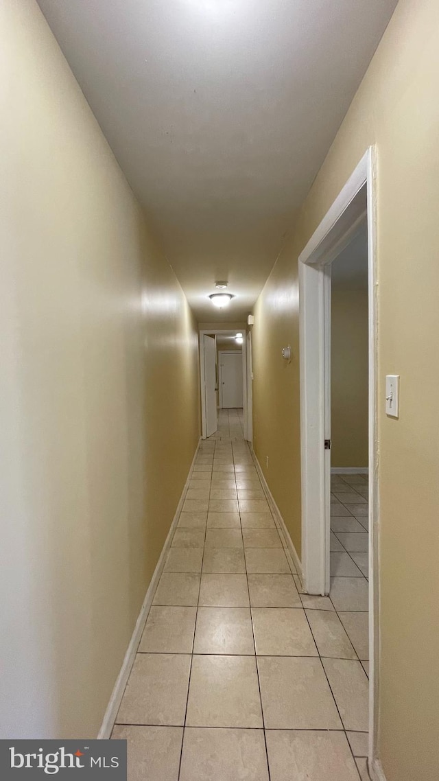 corridor featuring light tile patterned flooring