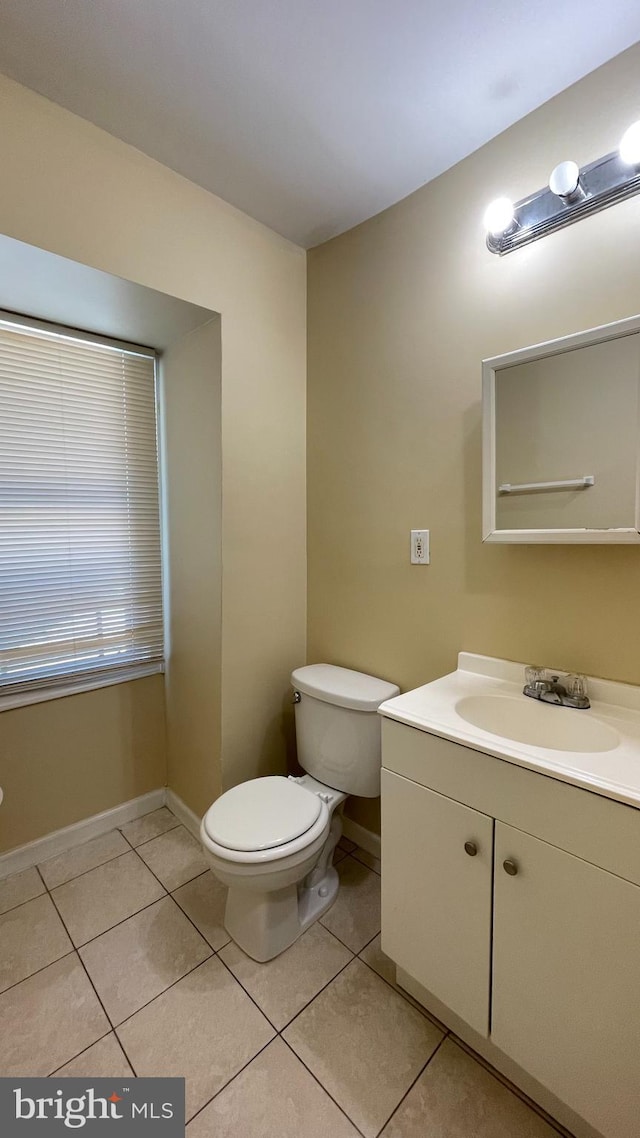 bathroom with vanity, toilet, and tile patterned floors