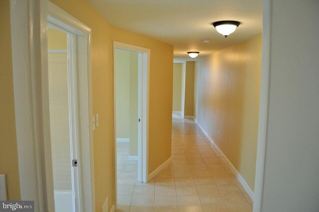 hall with light tile patterned floors