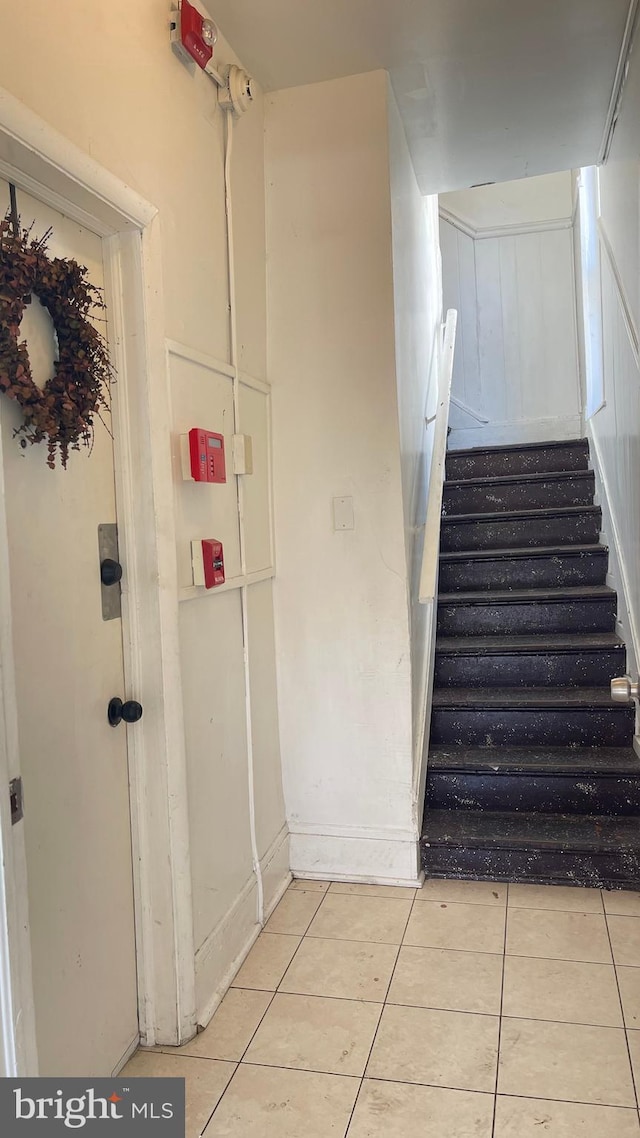 staircase with tile patterned flooring