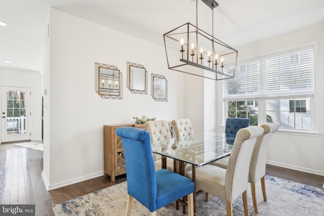 dining room featuring dark hardwood / wood-style floors and an inviting chandelier