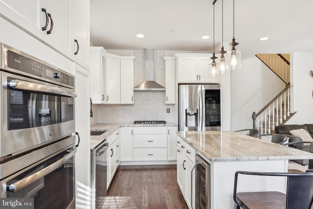 kitchen featuring stainless steel appliances, wine cooler, dark hardwood / wood-style flooring, white cabinets, and wall chimney exhaust hood