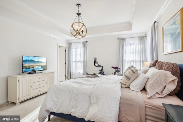 carpeted bedroom with a raised ceiling, multiple windows, and a chandelier