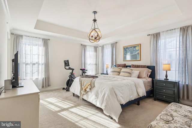 bedroom featuring light carpet, multiple windows, and a raised ceiling