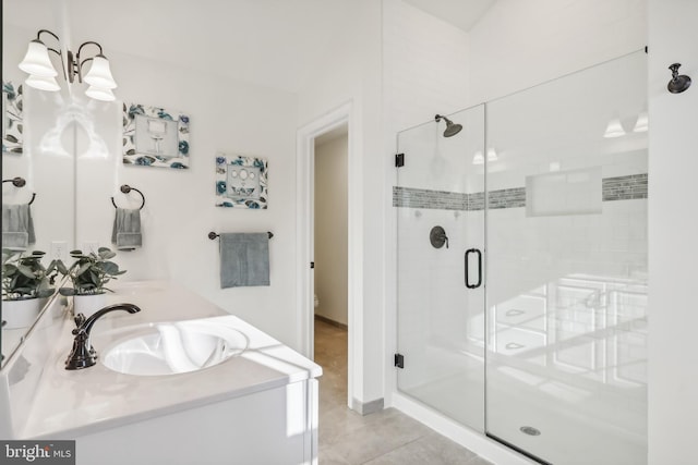 bathroom with vanity, an enclosed shower, and tile patterned floors