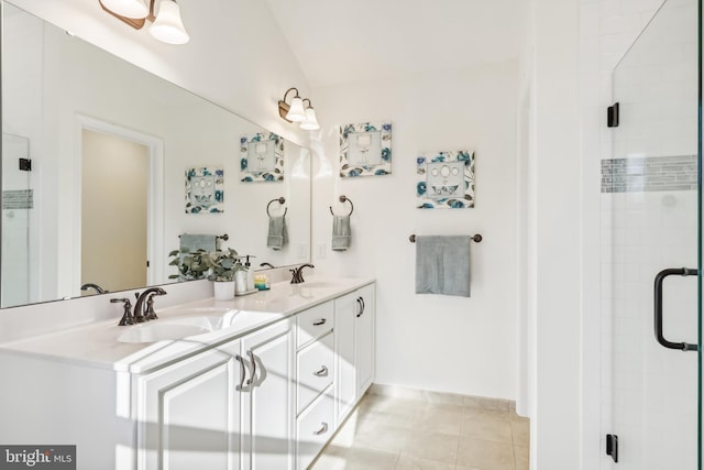 bathroom featuring tile patterned flooring, vanity, and a shower with shower door