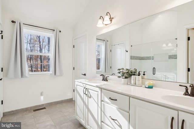 bathroom featuring vanity, an enclosed shower, tile patterned flooring, and lofted ceiling