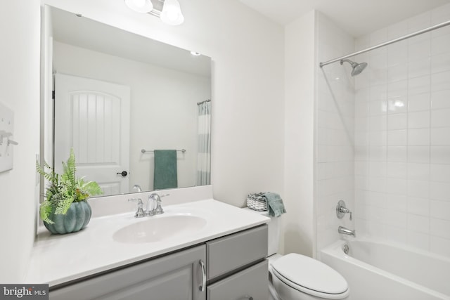 full bathroom featuring shower / bath combo, vanity, and toilet