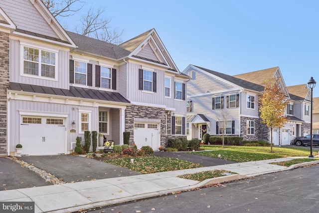 multi unit property with a garage and a front yard