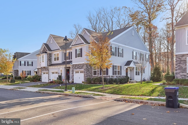 view of front of home with a garage and a front lawn