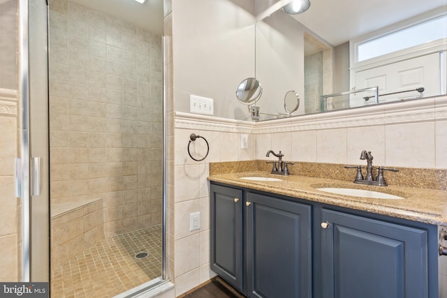 bathroom featuring vanity, tile walls, and a shower with shower door